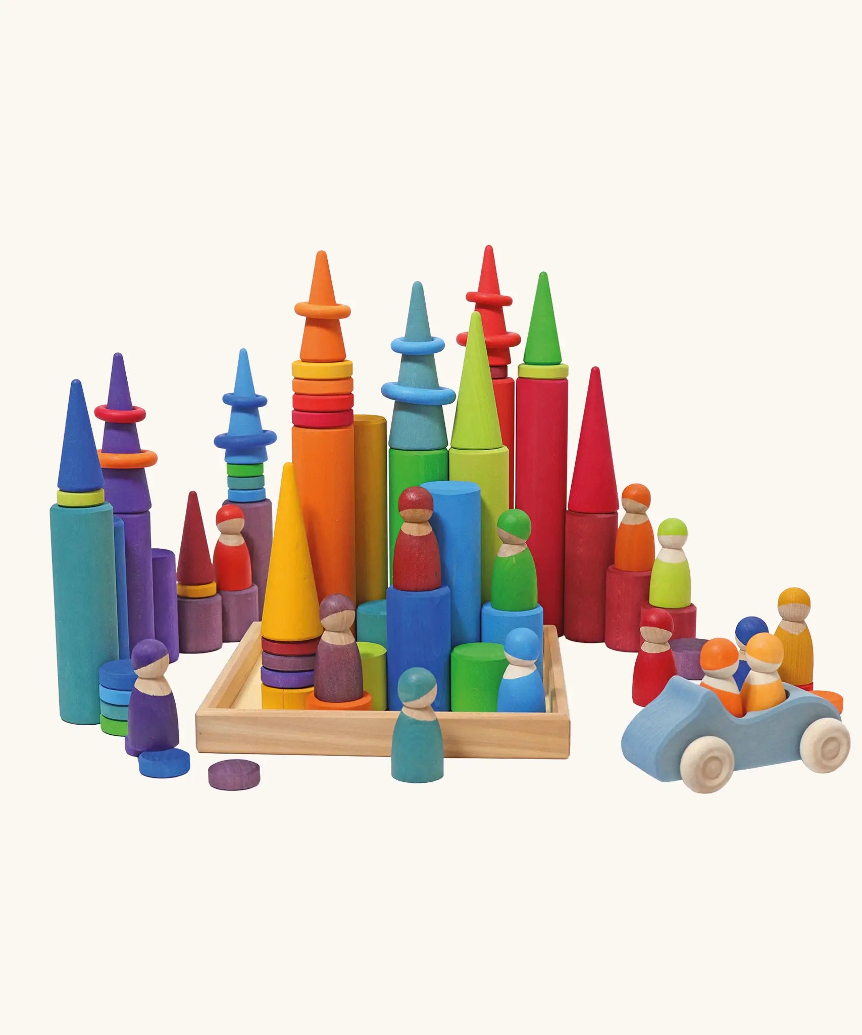 Grimm's large building rollers in bright rainbow colours in a wooden storage tray with other Grimm's wooden toys, friends peg dolls, rings, cars and forest cone shapes pieces.