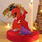 Grimm's Large Red Heart Celebration Ring with a number 2 decorative figure, a decorative vase and a candle. 