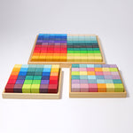 The Grimm's Large Mosaic Square placed behind the small version and the small pastel set. 