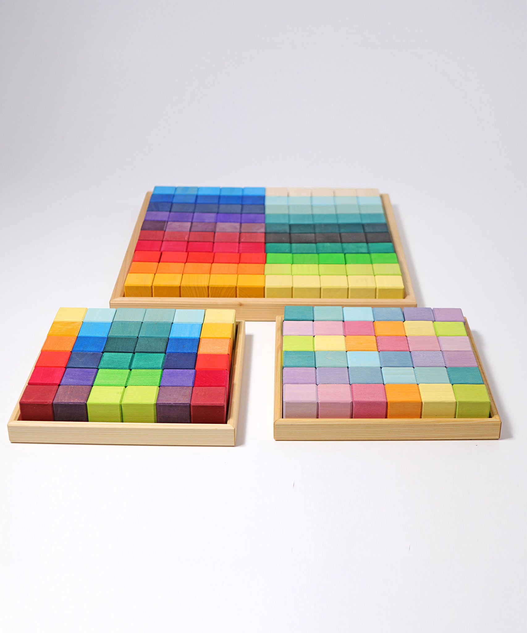 The Grimm's Large Mosaic Square placed behind the small version and the small pastel set. 
