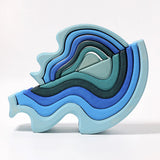 Grimms wooden blue water waves standing on top of a matching larger set