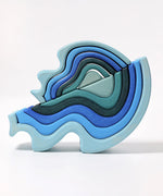 Grimms wooden blue water waves standing on top of a matching larger set
