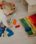 Grimms large stepped wooden counting blocks in Grimm’s World of Numbers palette made for counting and learning. 