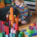 Grimm's large stepped pyramid coloured wooden blocks being played with by a child in the Babipur playroom.