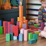 Grimm's large stepped pyramid coloured wooden block set played with by a young child an baby in the Babipur playroom.