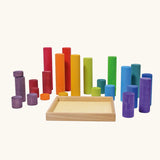 Grimm's large building rollers in bright rainbow colours with a wooden storage tray.