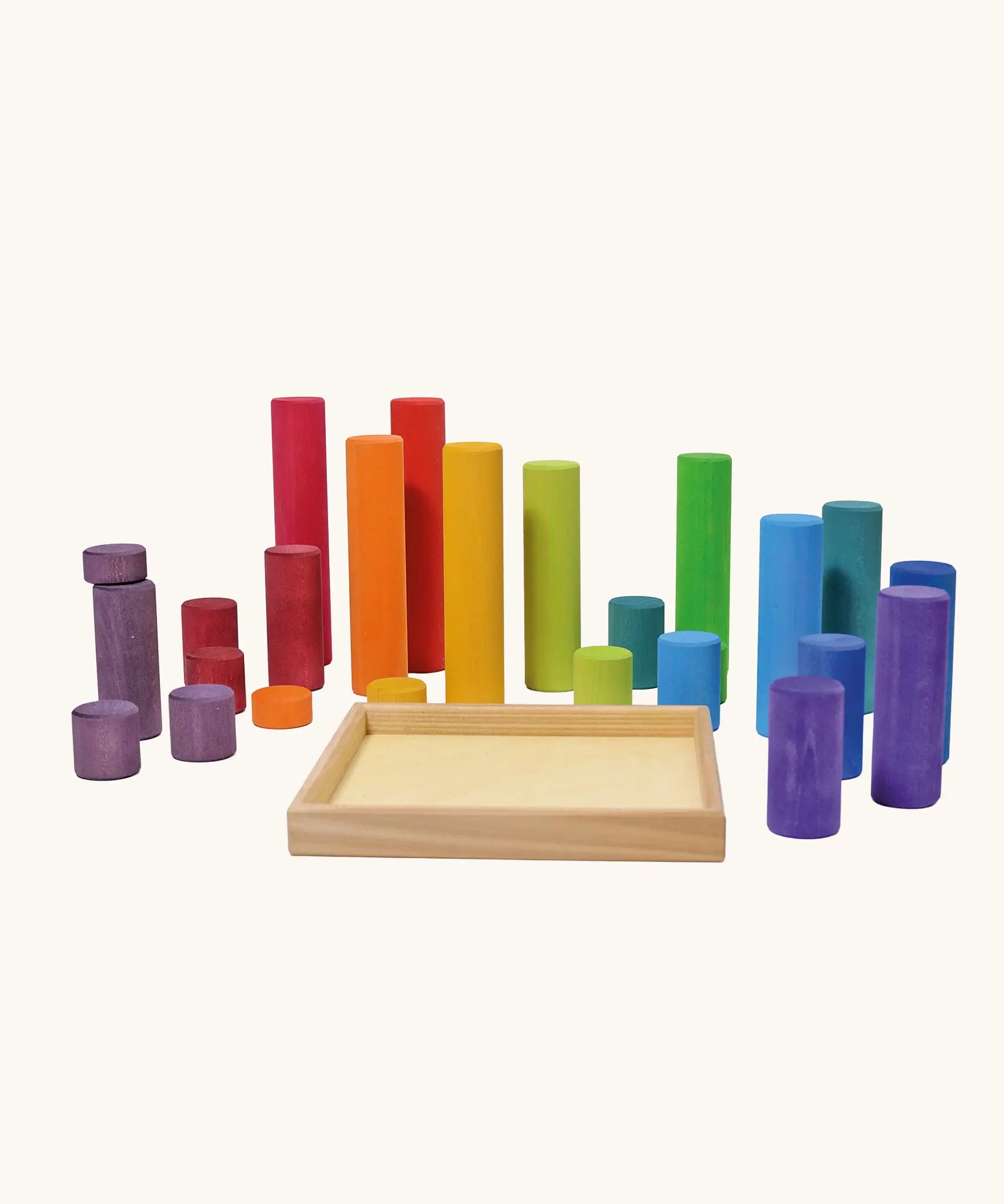 Grimm's large building rollers in bright rainbow colours with a wooden storage tray.