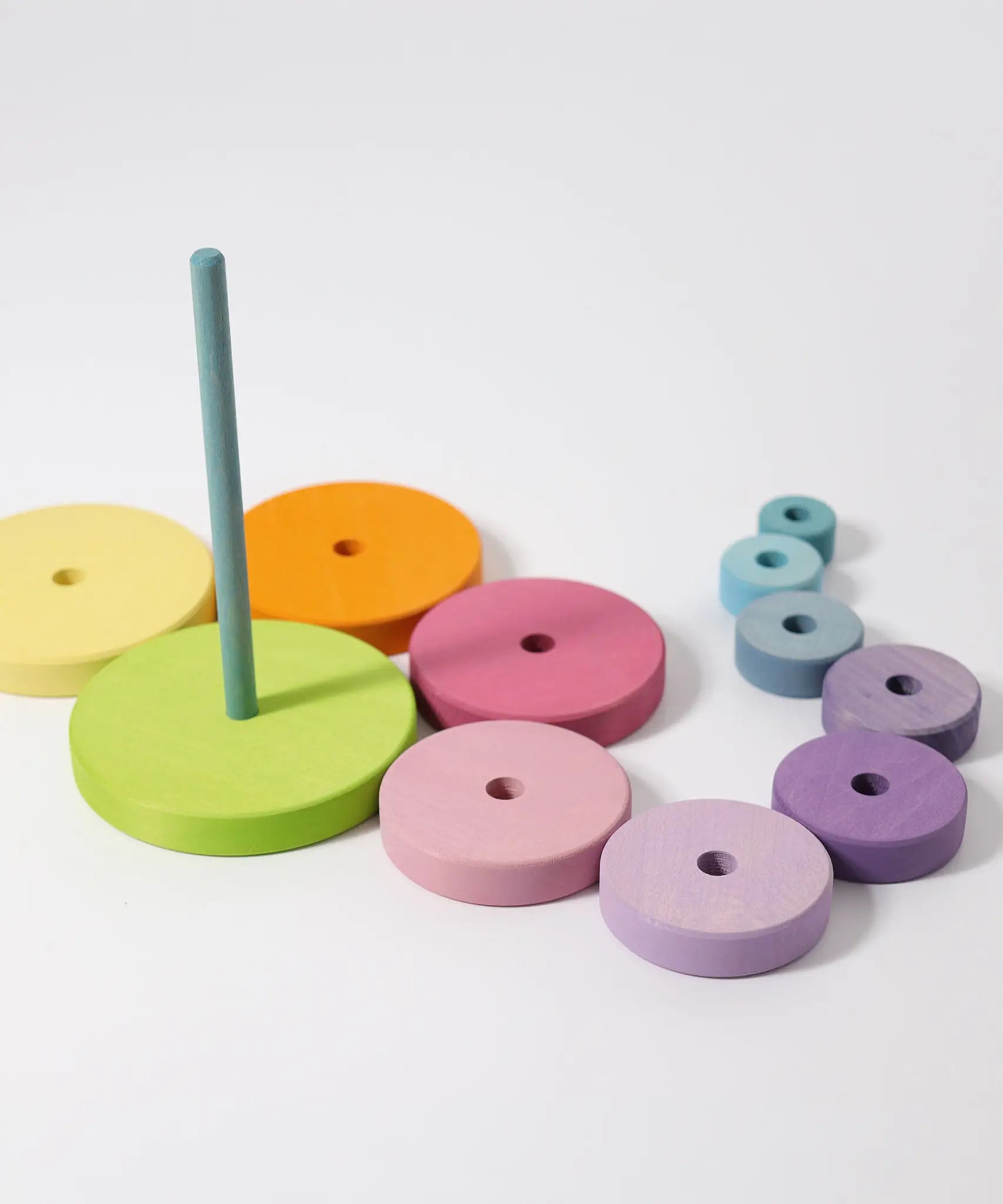 Loose wooden disk pieces from the Grimms large conical tower laid flat near the base with peg