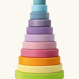 Grimms large wooden conical tower in pastel colours. A 11 piece set with chunky disk pieces, a base with a peg for stacking and counting games