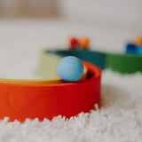 Close up of a Grimms small light blue ball on a ball run