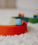 Close up of a Grimms small light blue ball on a ball run