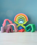 Loose pieces from the Grimms wooden little flower set stacked on top of each other