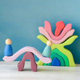 Pieces from the Grimms wooden little flower set made into a see saw with peg dolls sitting on top