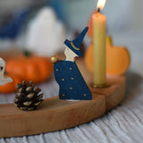 A Grimm's Magician Decorative Figure placed on a natural Grimm's celebration ring. 