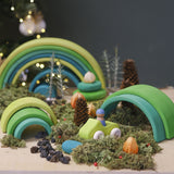 A cosy winter display using the Grimms meadow large wooden rainbow 12 piece set available at Babipur with various woodland pieces.