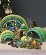 A cosy winter display using the Grimms meadow large wooden rainbow 12 piece set available at Babipur with various woodland pieces.