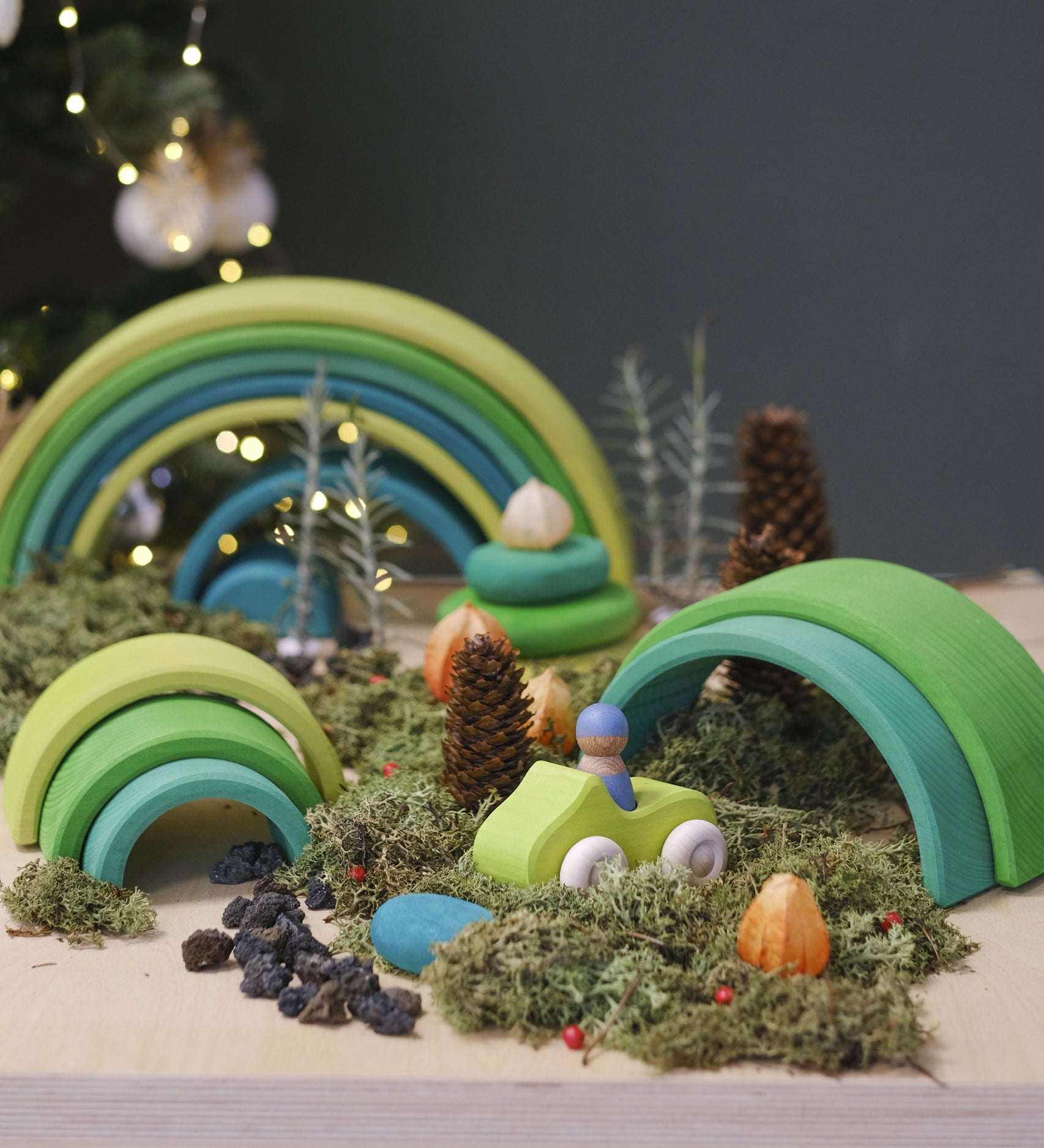 A cosy winter display using the Grimms meadow large wooden rainbow 12 piece set available at Babipur with various woodland pieces.