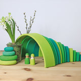 A cute little display using the Grimms meadow large green wooden rainbow, green pebbles and 2 green friends, all available at Babipur.