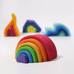The Grimm's Medium Rainbow (6 Pieces) on a white surface with the other Grimm's element toys, fire, earth and water in the background. 