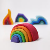 The Grimm's Medium Rainbow (6 Pieces) on a white surface with the other Grimm's element toys, fire, earth and water in the background. 