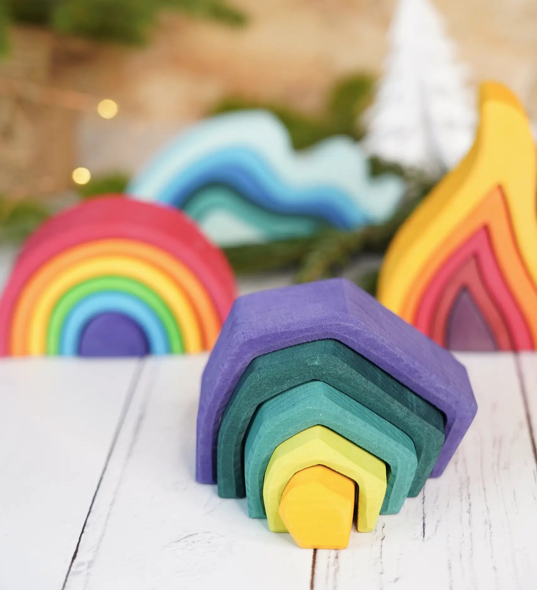 Grimm's mini earth set with a mini rainbow, fire and water waves in the bakground