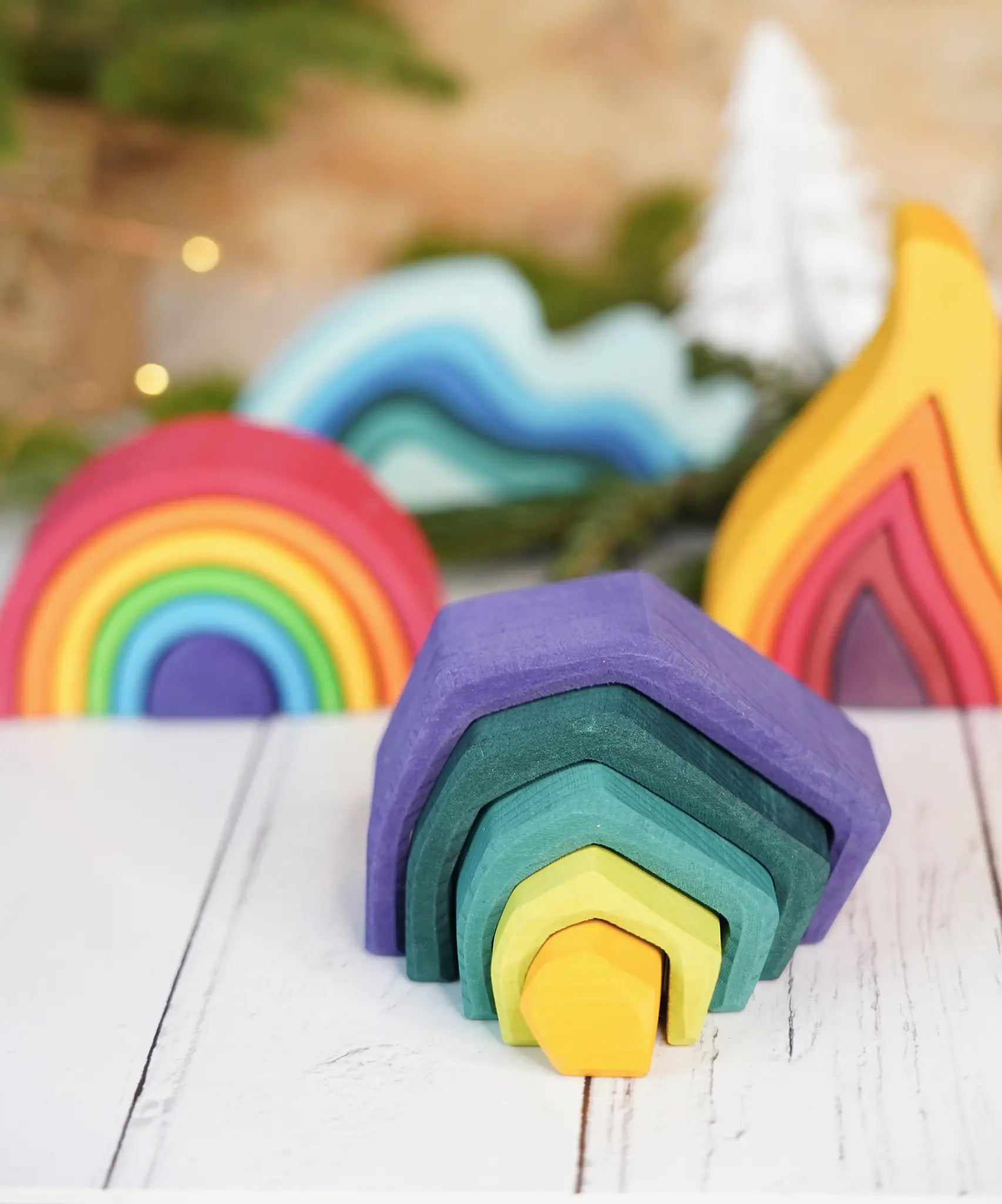 Grimm's mini earth set with a mini rainbow, fire and water waves in the bakground