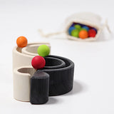 Grimm's mini monochrome wooden rainbow used as a mini ball run. 
