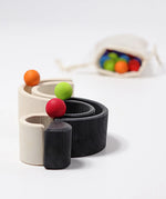 Grimm's mini monochrome wooden rainbow used as a mini ball run. 