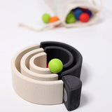 Grimm's mini monochrome wooden rainbow used as a mini ball run. 