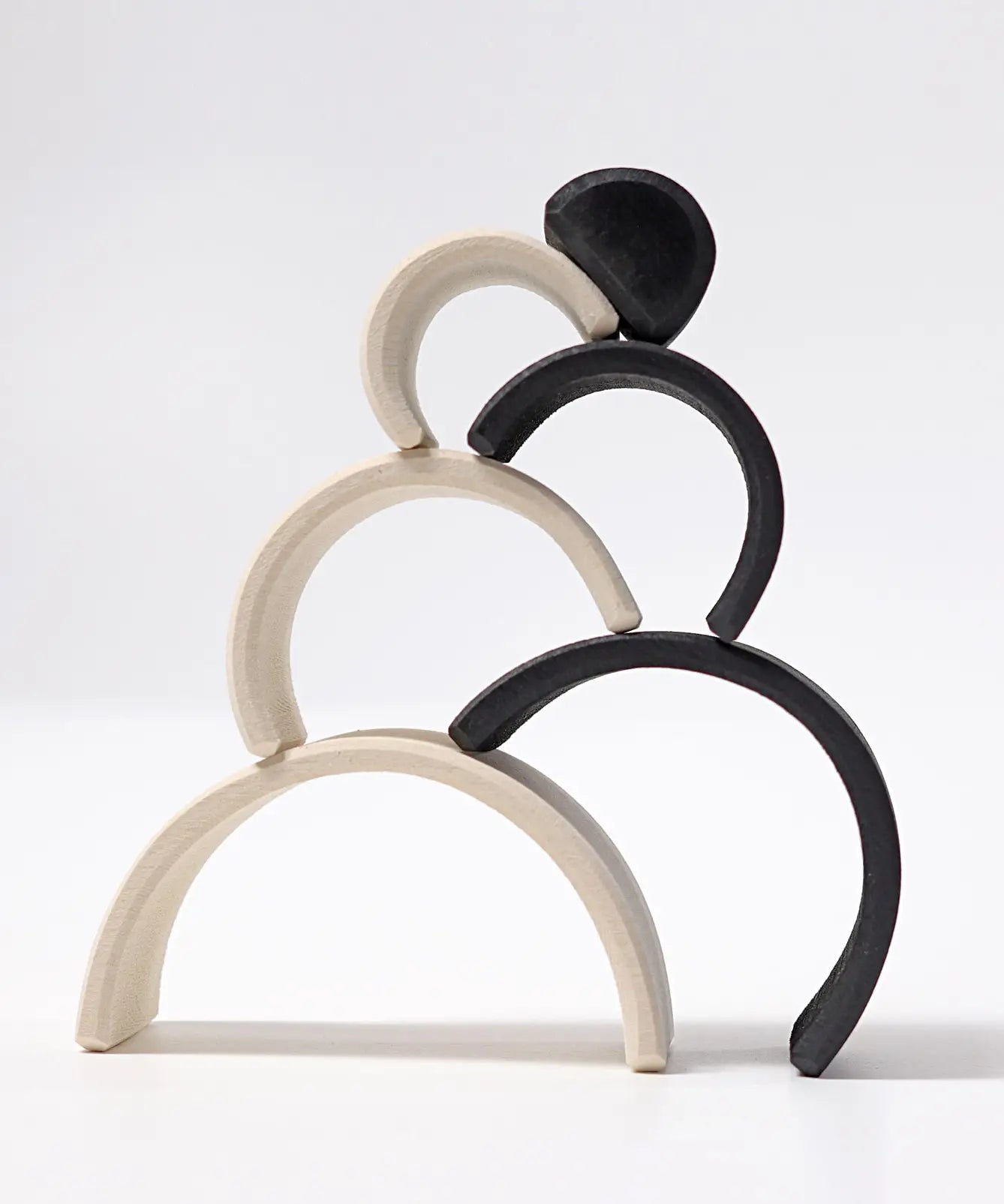 Grimm's mini monochrome wooden rainbow stacked up.