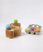 A mini ball run made from piece Grimms rainbow stacking toy available at Babipur with the pastel balls running along the top