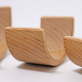 A close up of the Grimms natural wooden rainbow stacking toy available at Babipur showing the grain detail on the arch