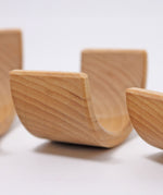 A close up of the Grimms natural wooden rainbow stacking toy available at Babipur showing the grain detail on the arch