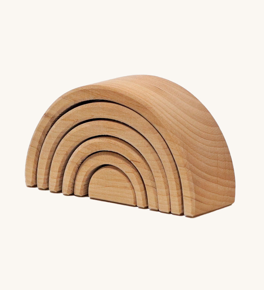 A mini wooden Grimms rainbow stacking toy available at Babipur. This unpainted stacking toy in handmade and has 6 pieces 