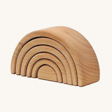 A mini wooden Grimms rainbow stacking toy available at Babipur. This unpainted stacking toy in handmade and has 6 pieces 