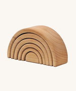 A mini wooden Grimms rainbow stacking toy available at Babipur. This unpainted stacking toy in handmade and has 6 pieces 
