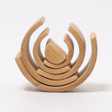 Pieces from the Grimms natural wooden rainbow made into a stack. This  set is available at Babipur. 