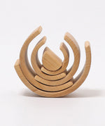 Pieces from the Grimms natural wooden rainbow made into a stack. This  set is available at Babipur. 