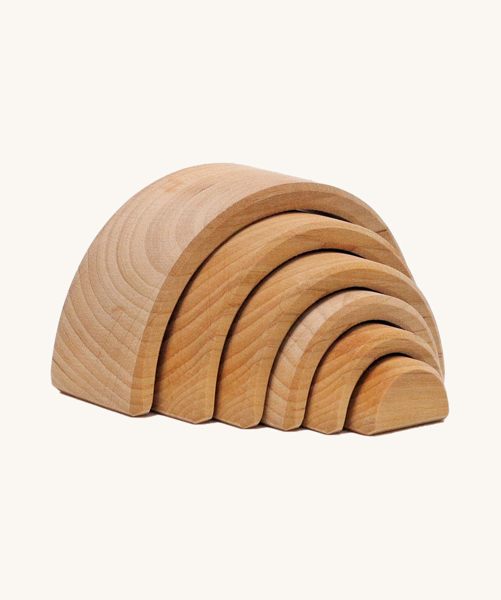 A mini wooden Grimms rainbow stacking toy available at Babipur. This rainbow tunnel stacking toy is handmade and unpainted