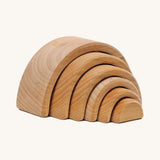 A mini wooden Grimms rainbow stacking toy available at Babipur. This rainbow tunnel stacking toy is handmade and unpainted