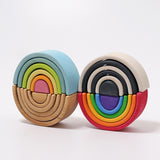 A Grimms mini pastel, natural, monochrome and bright rainbow stacking toy on top of each other. These sets are available at Babipur