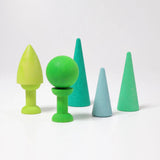 Pieces of the Grimmswooden forest set in shades of green showing a ball and cone piece balancing on the bobbins