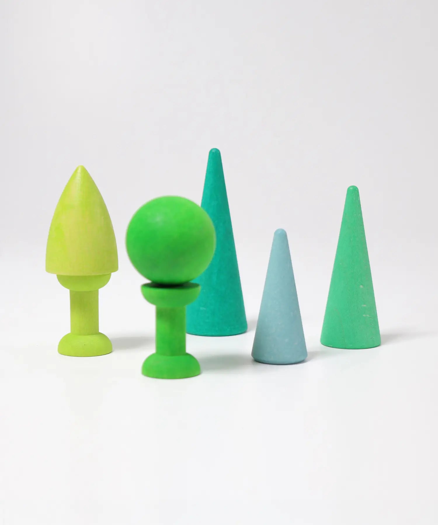Pieces of the Grimmswooden forest set in shades of green showing a ball and cone piece balancing on the bobbins