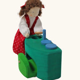 Grimm's blue and green mobile dolls home wooden toy play set sink with doll placed besides it.