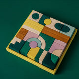 Grimm's wooden movement hand crafted pieces in a yellow square frame against a green background