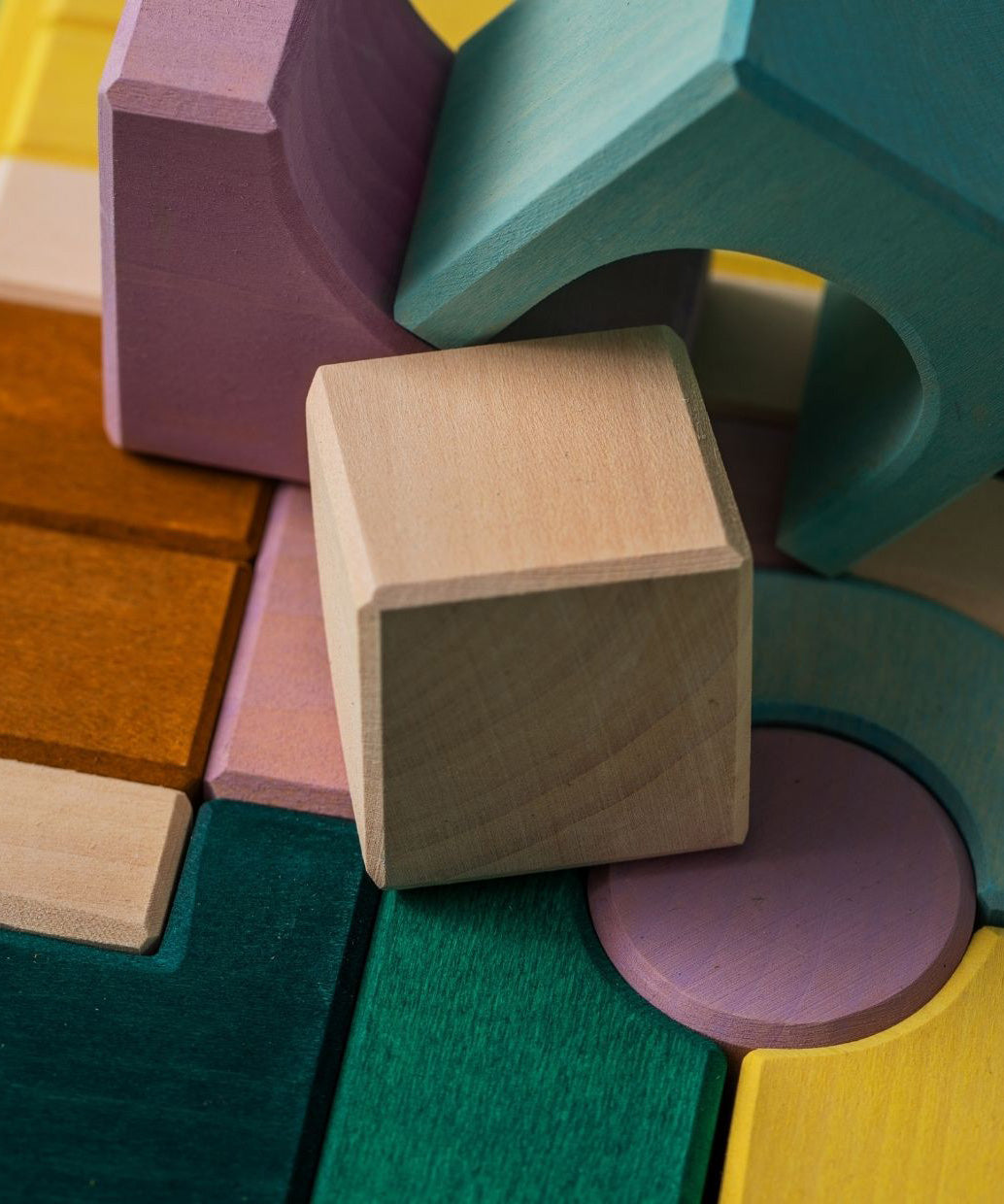 A close of a white wooden tactile piece  from the Grimms movement set showing the hard carved detail