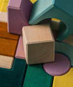 A close of a white wooden tactile piece  from the Grimms movement set showing the hard carved detail