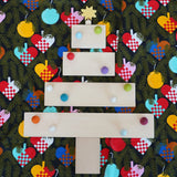 A festive flatlay showing a Christmas tree made from Grimms wooden natural building boards 