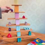 A tree structure made from Grimms wooden natural building boards and other pastel building blocks