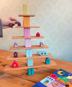 A tree structure made from Grimms wooden natural building boards and other pastel building blocks